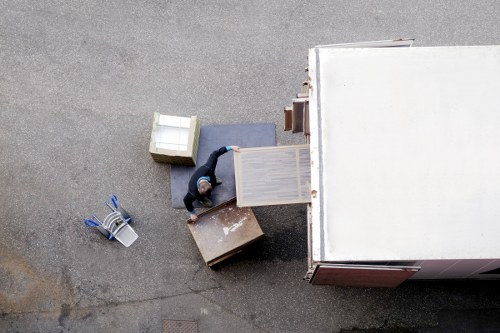 Helper loading furniture into a moving van during a Motspurpark relocation