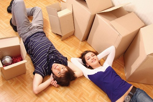 Professional movers handling boxes during a small removal in Motspurpark
